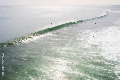 Aerial of Surfers on long hurricane waves in Rhode Island