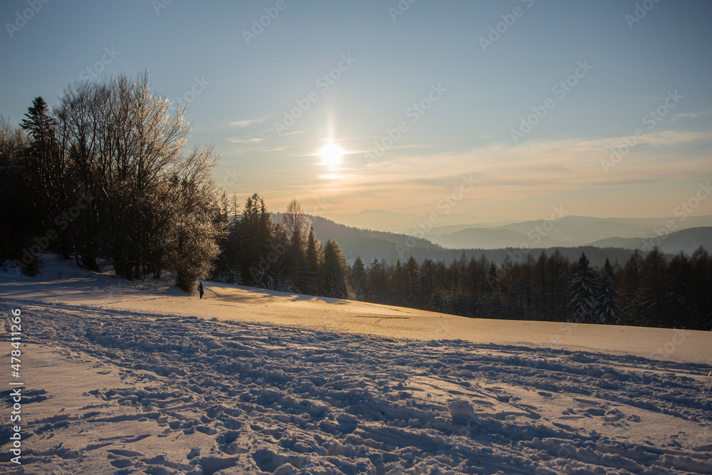 a winter mountain glade in the background the setting sun, mountain mood, Beskid Sądecki a winter mountain glade in the background the setting sun, mountain mood, Beskid Sądecki