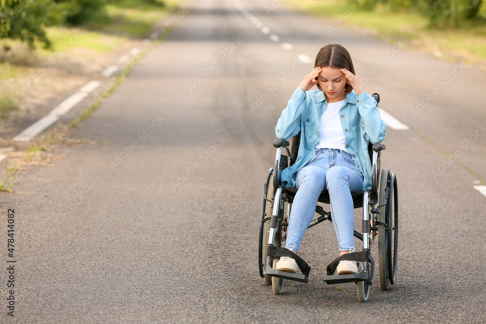 Depressed young woman with physical disability outdoors Depressed young woman with physical disability outdoors
