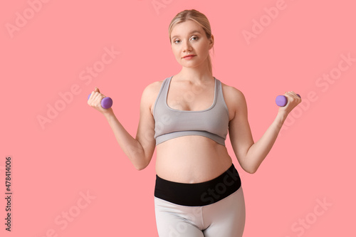 Sporty young pregnant woman...