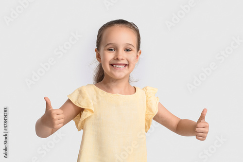 Funny little girl showing t...