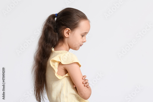 Sad little girl in yellow b...