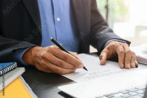 Businessman working with document at desk in office, closeup © Pixel-Shot