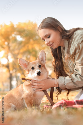 Young woman with cute Corgi...