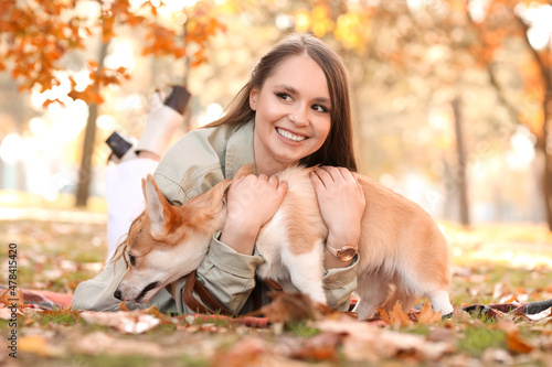 Young woman with cute Corgi...