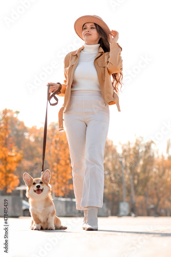 Stylish young woman walking...