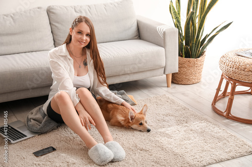 Young woman with cute Corgi...