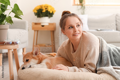 Young woman with cute Corgi...