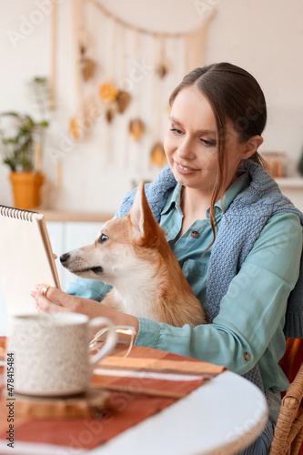 Young woman with cute Corgi...