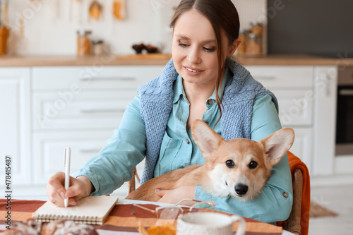 Young woman with cute Corgi...
