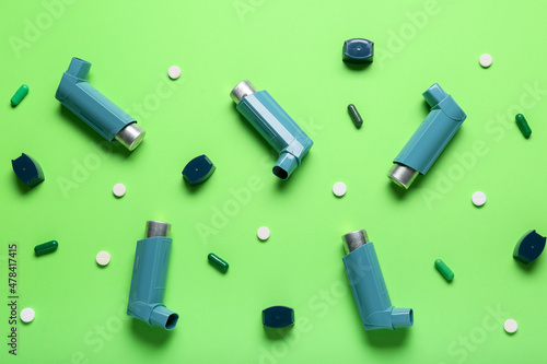 Composition with asthma inhalers and pills on green background