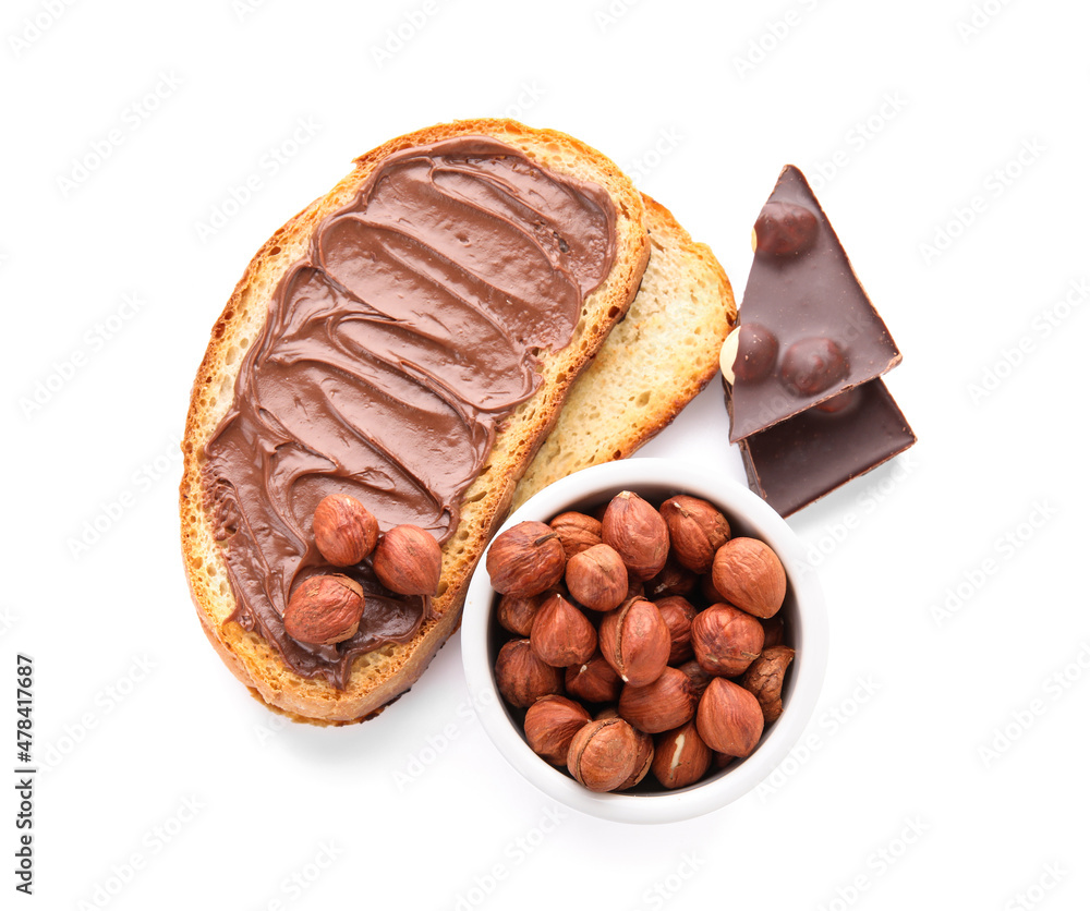 Bread with chocolate paste and hazelnuts on white background Bread with chocolate paste and hazelnuts on white background