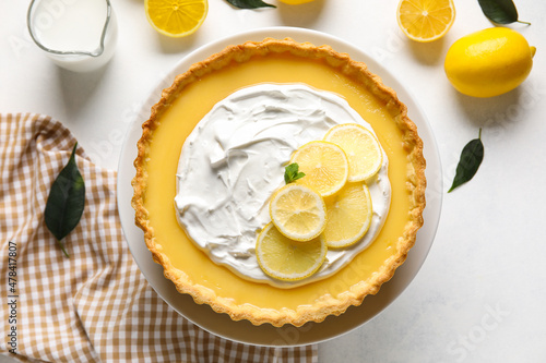 Stand with delicious lemon tart on light background photo