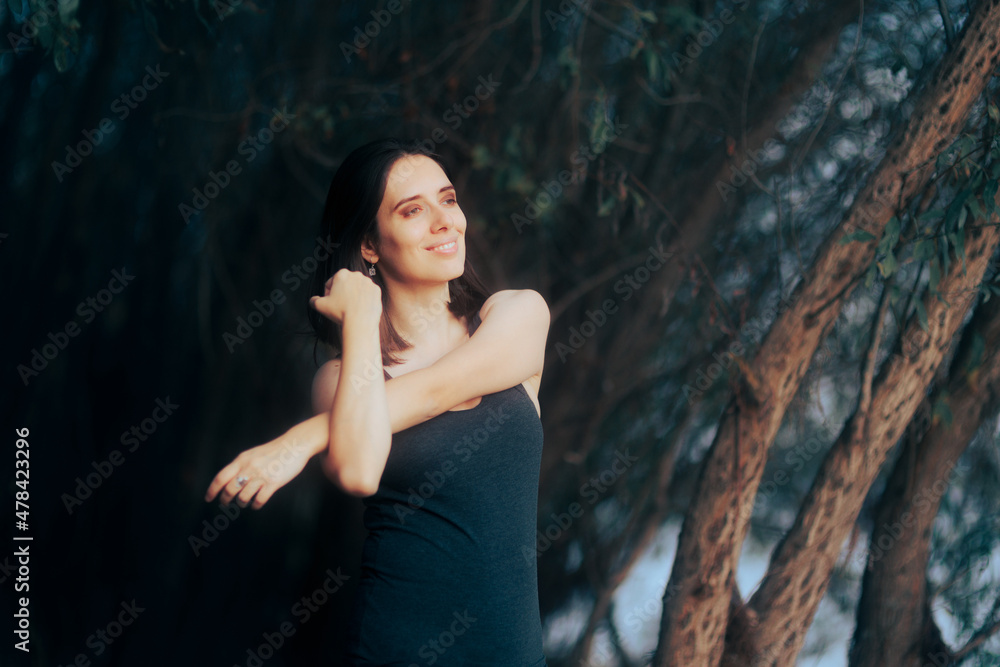 Fototapeta premium Happy Woman Relaxing and Stretching her Arms Outdoors