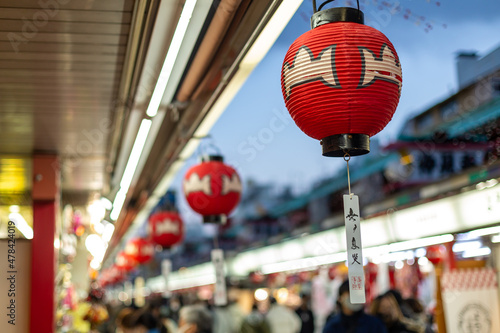 traditional red paper lanterns hanged and lined up from the eaves of nakamise shopping street in asakusa on december 31st 2021
