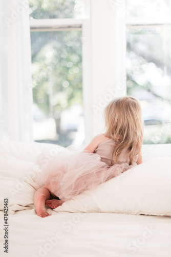 Wallpaper Mural Little girl looking out the window waiting Torontodigital.ca