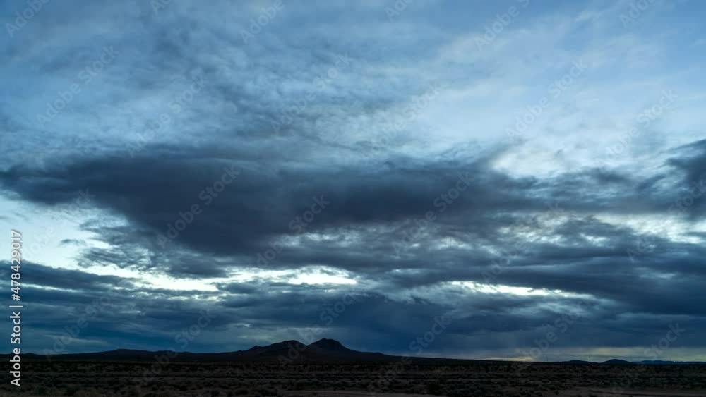 Mojave Desert on an overcast night with the sunrise brining a colorful dawn - wide angle static time lapse Mojave Desert on an overcast night with the sunrise brining a colorful dawn - wide angle static time lapse