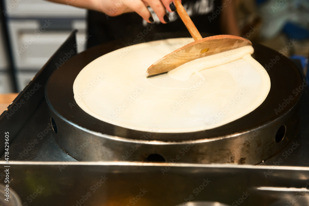Obraz premium Prepare sweet crepes batter with wood, on white isolated.