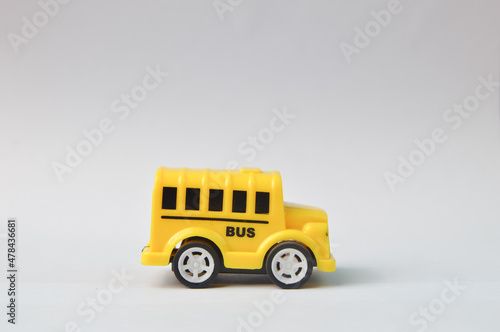 Yellow toy bus isolated on a white background