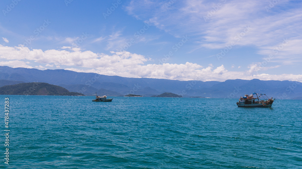 Lonely boat in the blue sea under blue sky