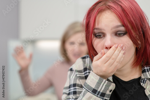 Family conflict. Mother screams at crying teen daughter