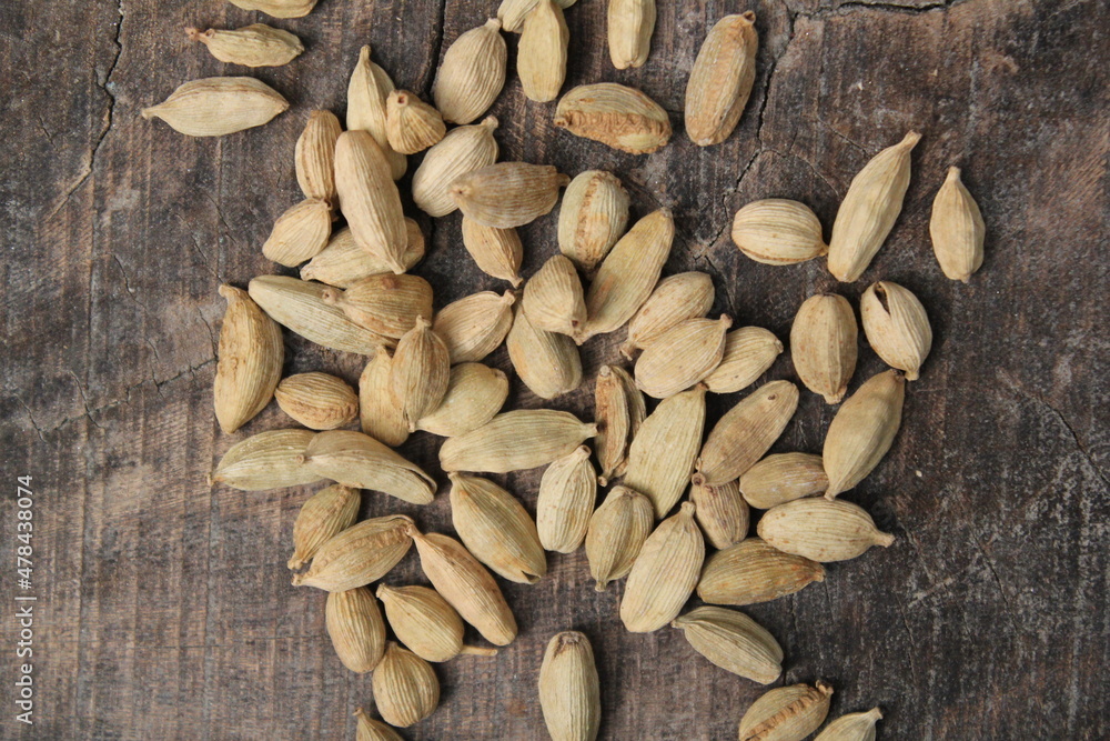 Dried cardamom on a wooden background Dried cardamom on a wooden background