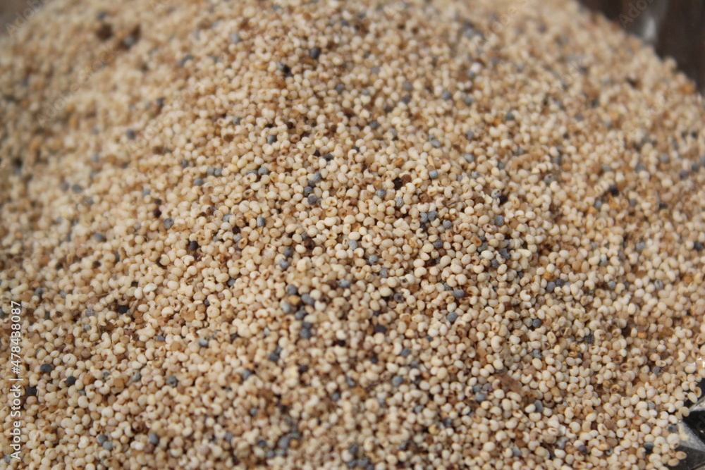 White poppy seeds on a glass bowl White poppy seeds on a glass bowl