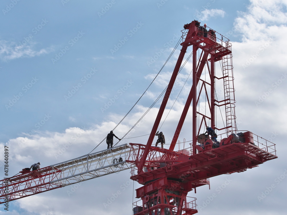 Tokyo,Japan - October 25, 2021: Assembly of a tower crane. Connecting a jib with the tower.
Tokyo,Japan - October 25, 2021: Assembly of a tower crane. Connecting a jib with the tower.