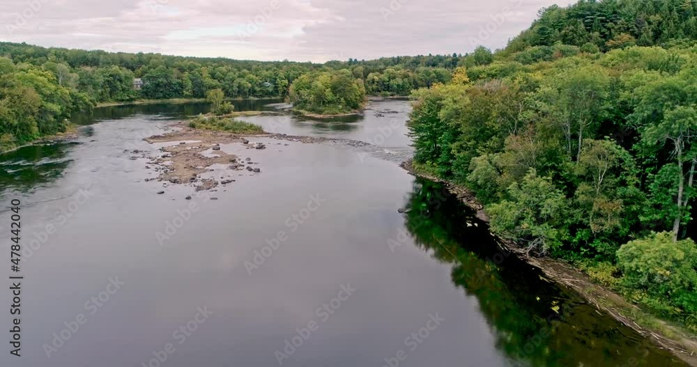 Drone crane view coming down slowly over the Batiscan river on a cloudy day in Fall Drone crane view coming down slowly over the Batiscan river on a cloudy day in Fall