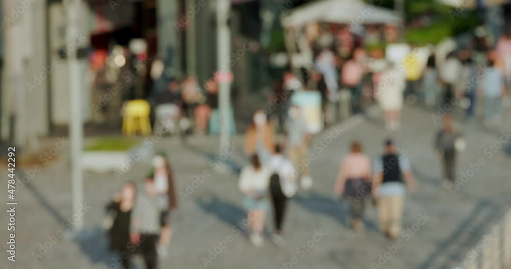 Blur view of people walk in the street at sunset time Blur view of people walk in the street at sunset time