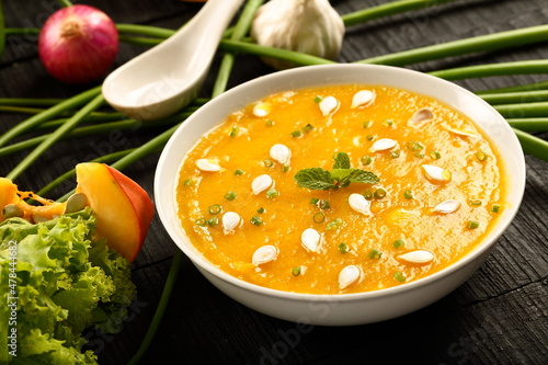 Bowl of delicious vegan diet meal- healthy organic pumpkin soup with fresh cream.