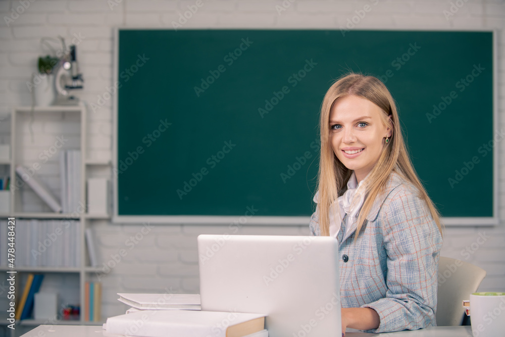 Portrait of female university student study lesson, sitting at table and writing on notebook at school or university. Portrait of female university student study lesson, sitting at table and writing on notebook at school or university.
