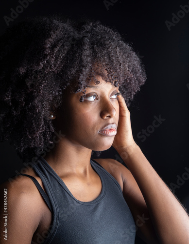 pretty afro american woman in studio dark background pretty model, makeup, seriousness