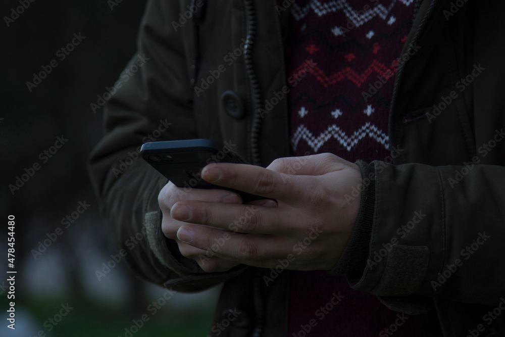 man in coat using mobile phone on the street man in coat using mobile phone on the street