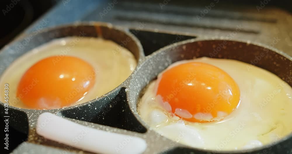 Close up Cooking Scrambled Eggs Fried Eggs on the Stove in a Frying Pan for breakfast food, The Concept of Protein Healthy Food and Diet Close up Cooking Scrambled Eggs Fried Eggs on the Stove in a Frying Pan for breakfast food, The Concept of Protein Healthy Food and Diet