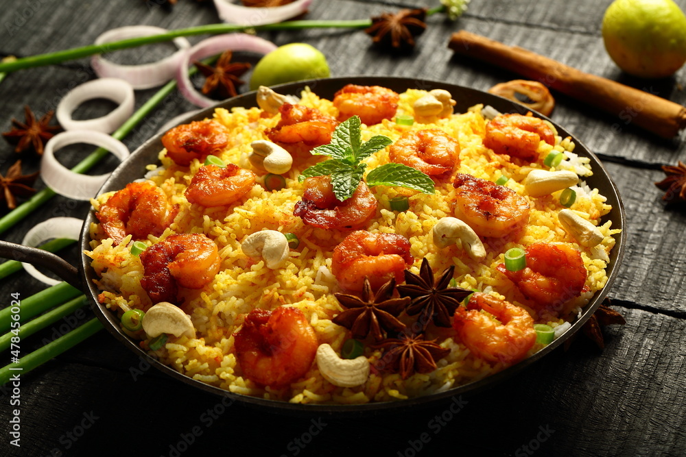 Bowl of delicious, spicy cooked seafood biryani, pilaf, Asian traditional recipes background. Bowl of delicious, spicy cooked seafood biryani, pilaf, Asian traditional recipes background.
