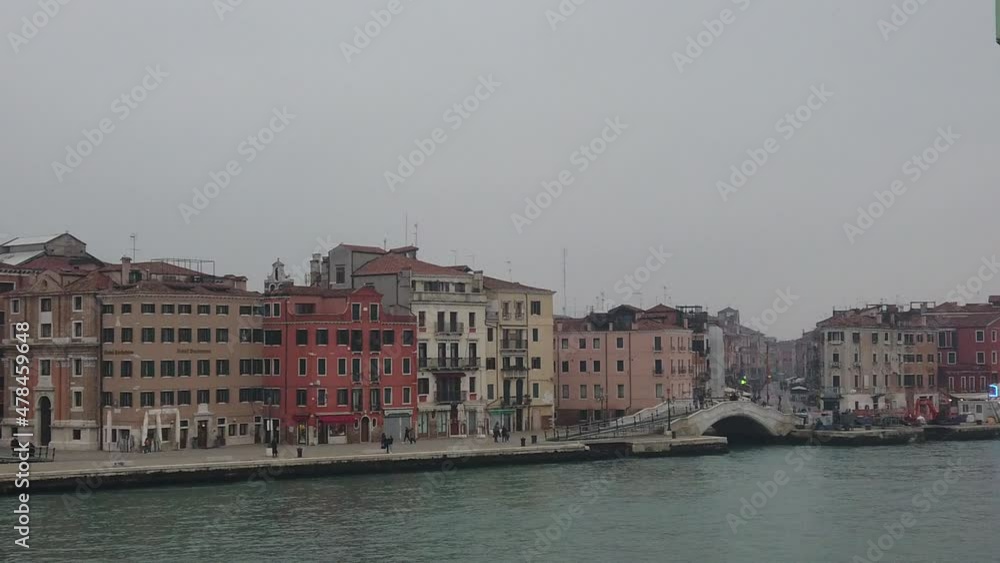 Venice, Italy - January 2022 - Traveling on the ferry that transports cars, along the Giudecca canal, among the splendid historic buildings of the lagoon city Venice, Italy - January 2022 - Traveling on the ferry that transports cars, along the Giudecca canal, among the splendid historic buildings of the lagoon city