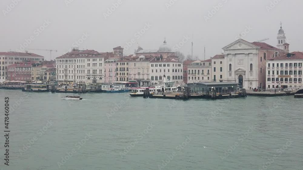 Venice, Italy - January 2022 - Traveling on the ferry that transports cars, along the Giudecca canal, among the splendid historic buildings of the lagoon city Venice, Italy - January 2022 - Traveling on the ferry that transports cars, along the Giudecca canal, among the splendid historic buildings of the lagoon city