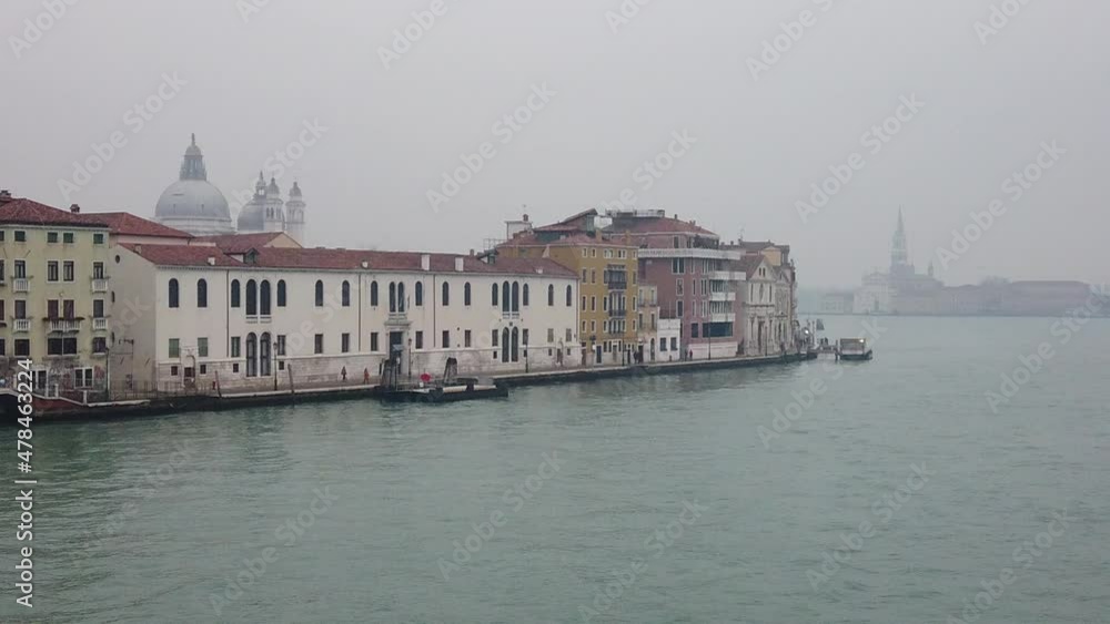 Venice, Italy - January 2022 - Traveling on the ferry that transports cars, along the Giudecca canal, among the splendid historic buildings of the lagoon city Venice, Italy - January 2022 - Traveling on the ferry that transports cars, along the Giudecca canal, among the splendid historic buildings of the lagoon city