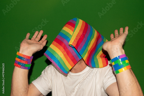Head disappears behind a gender rainbow flag