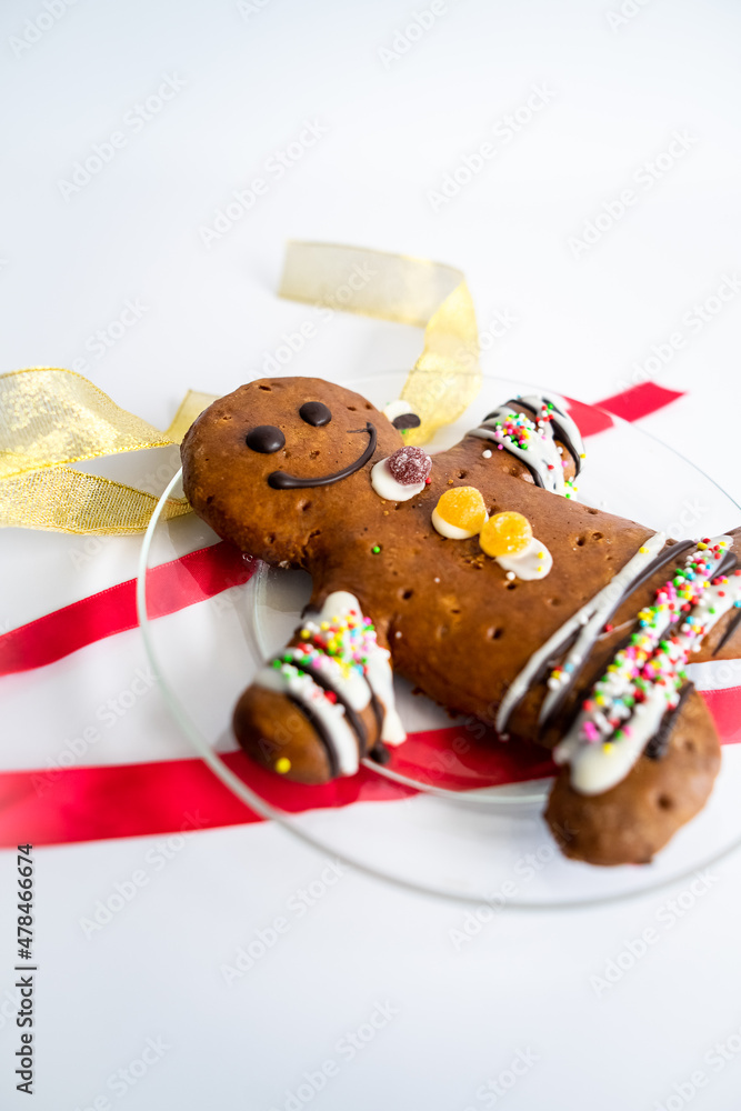 Gingerbread man and Christmas decor on white background.