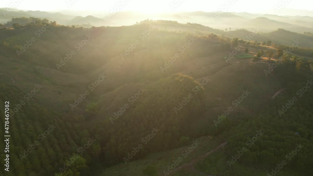 Aerial view of sunrise with fog above mountains. Golden hour and amazing sun rays. Nan, Thailand
Aerial view of sunrise with fog above mountains. Golden hour and amazing sun rays. Nan, Thailand