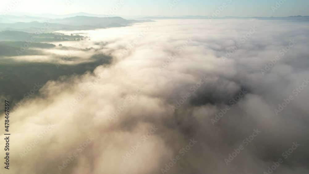 4K aerial view over mountain at sunrise in heavy fog. golden morning sunlight
4K aerial view over mountain at sunrise in heavy fog. golden morning sunlight