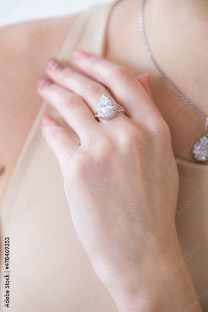 Trendy silver ring on a beautiful young girl in a white fashionable jacket. Beauty and fashion
Trendy silver ring on a beautiful young girl in a white fashionable jacket. Beauty and fashion