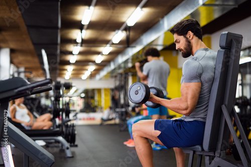 Portrait of fit man working out in gym. Sport people healthy lifestyle exercise concept