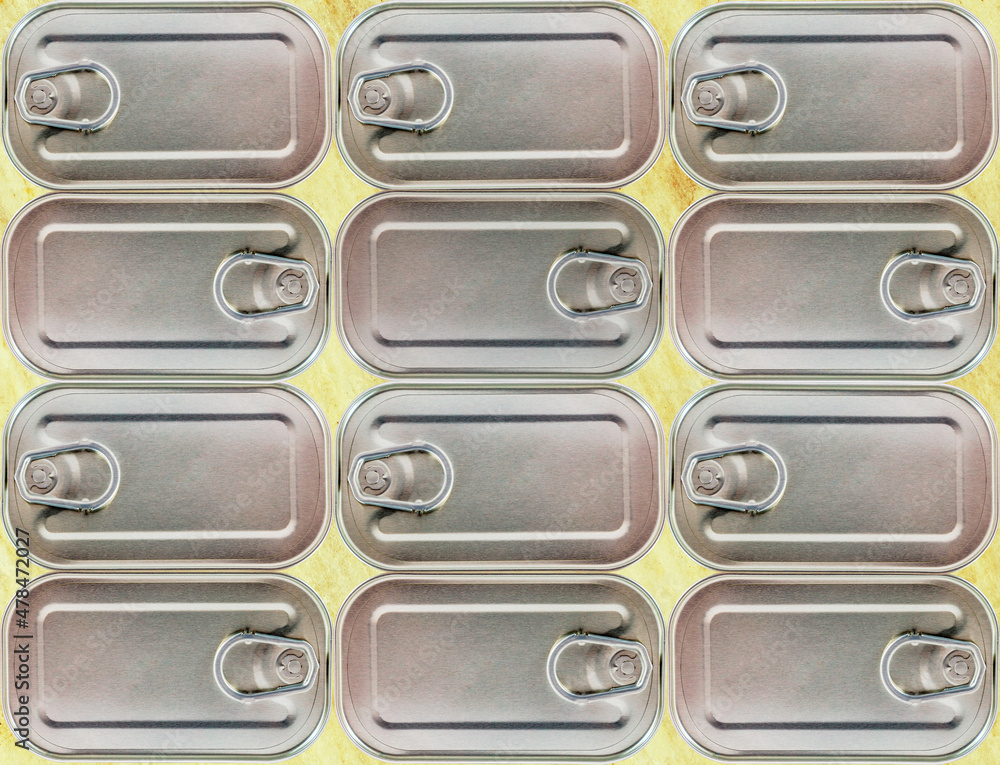 Obraz premium Close up of canning tins on yellow background.