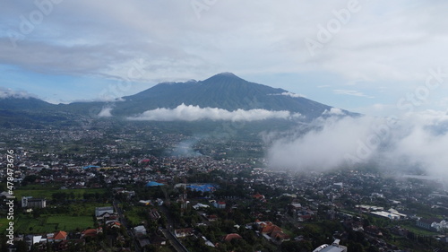 Drone shot of mountain in Batu City, Indonesia surrounded with clouds