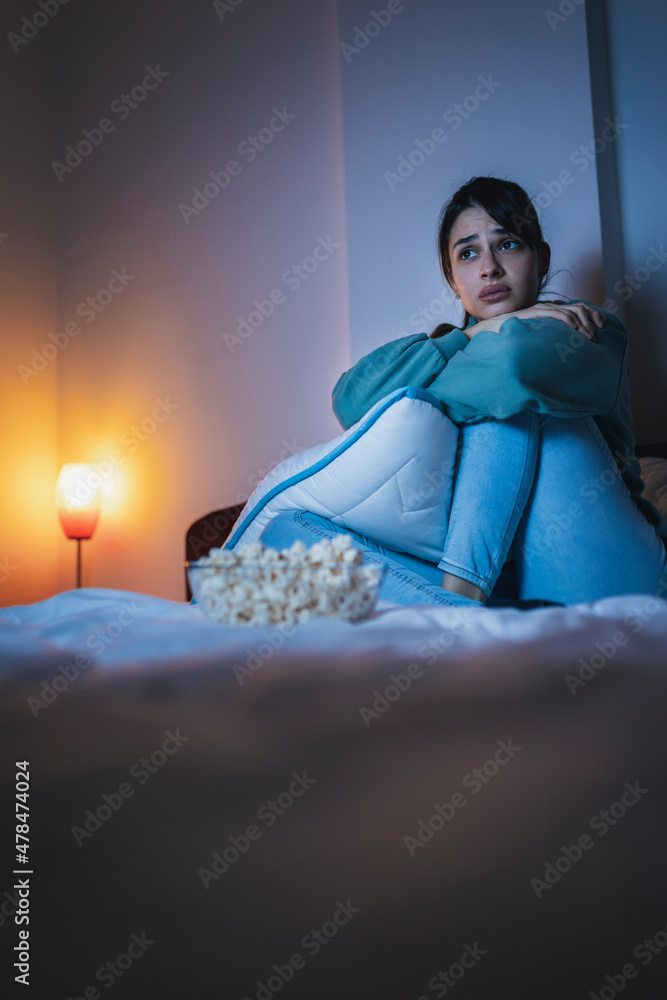 Woman watching sad movie on TV Woman watching sad movie on TV
