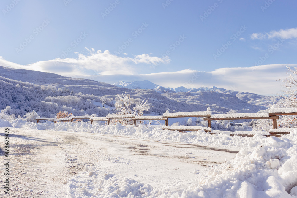 Landscape of Tuscan-Emilian Apennines in Ventasso, Italy. Snowcapped mountains and vegetation in winter. Copy space.