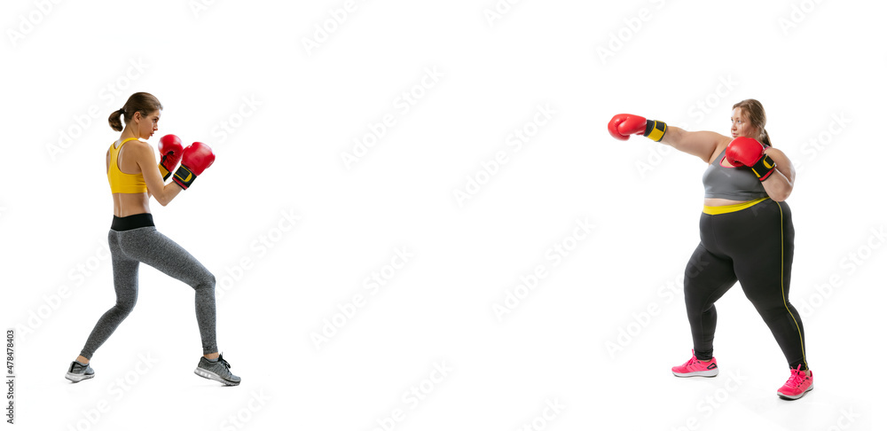 Happy young slim girl and plus-size woman wearing sport uniform isolated on white background. Concept of healthy lifestyle, fitness, sport, nutrition and weight loss.